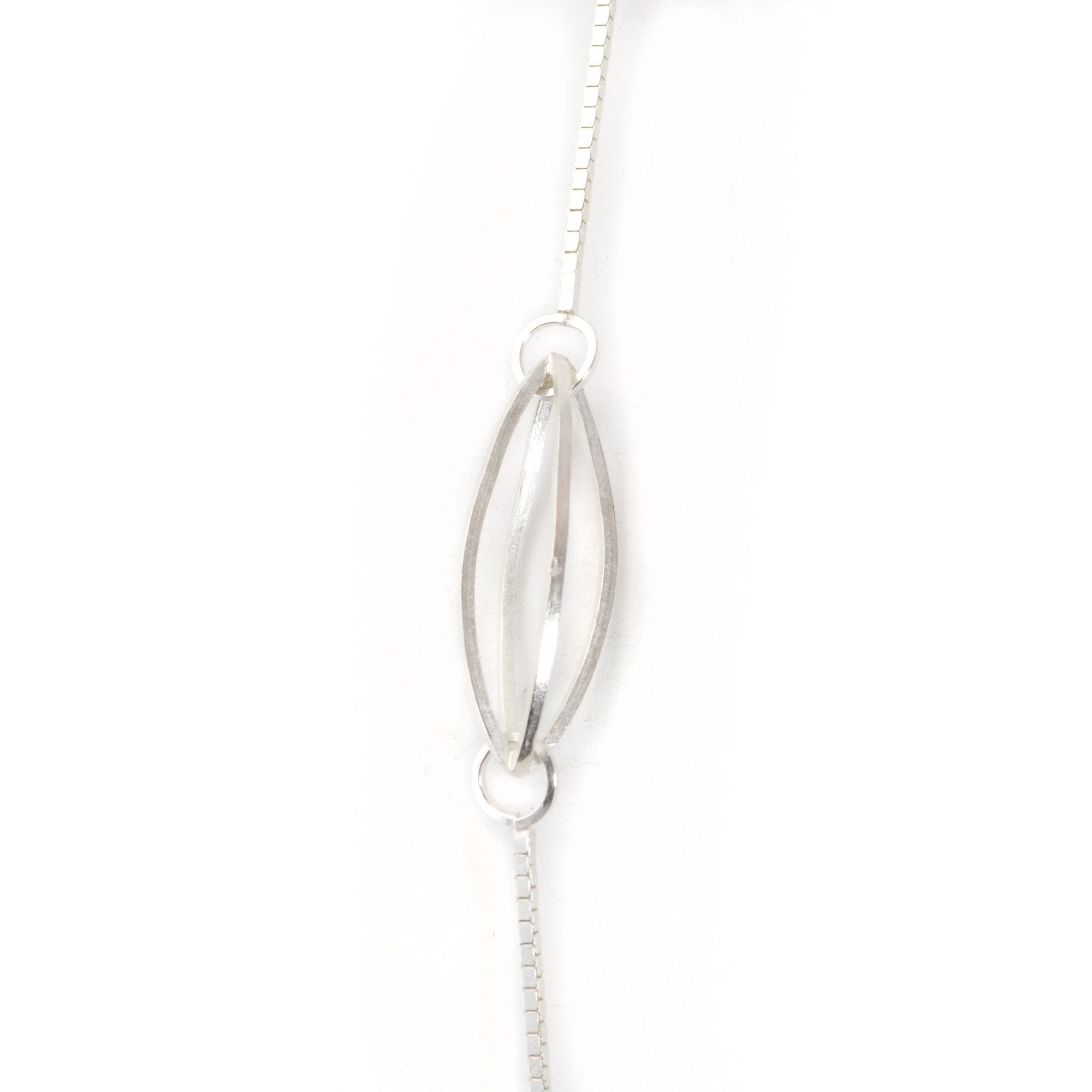 Streamline Lattis Shapes form a Minimal Siloutte on this Long Necklace in Sterling Silver